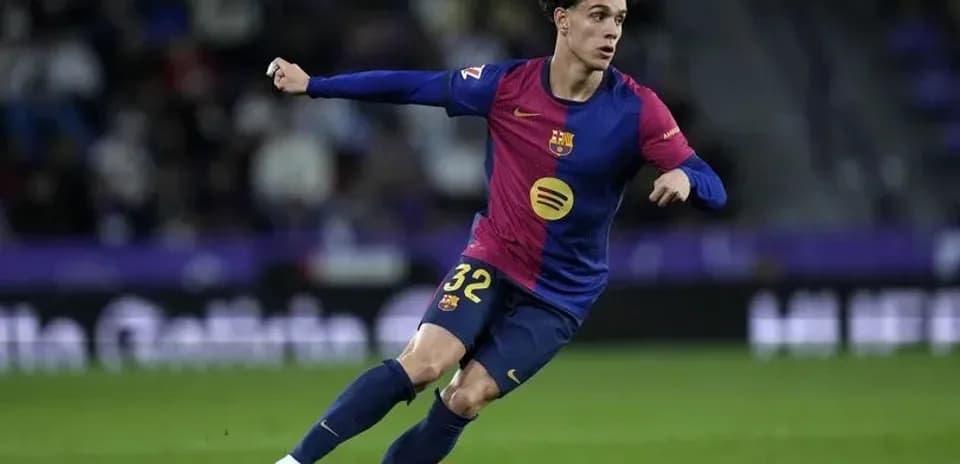 Futbolchi Barcelona formasida to'pni quvlayapti