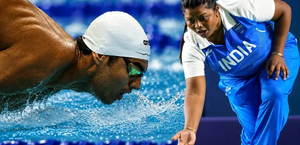 Swiimmer competing with coach at the poolside