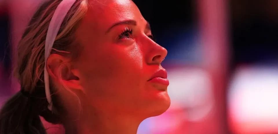 Basketball player looking up under arena lights