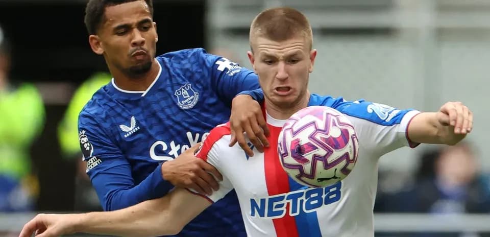 Everton player challenges for the ball against opponent