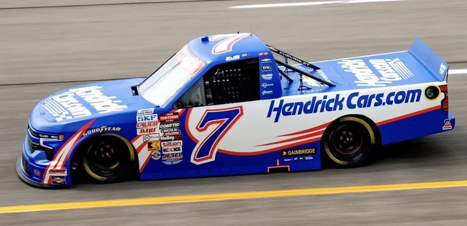 Chevrolet truck racing on track with Hendrick Cars livery