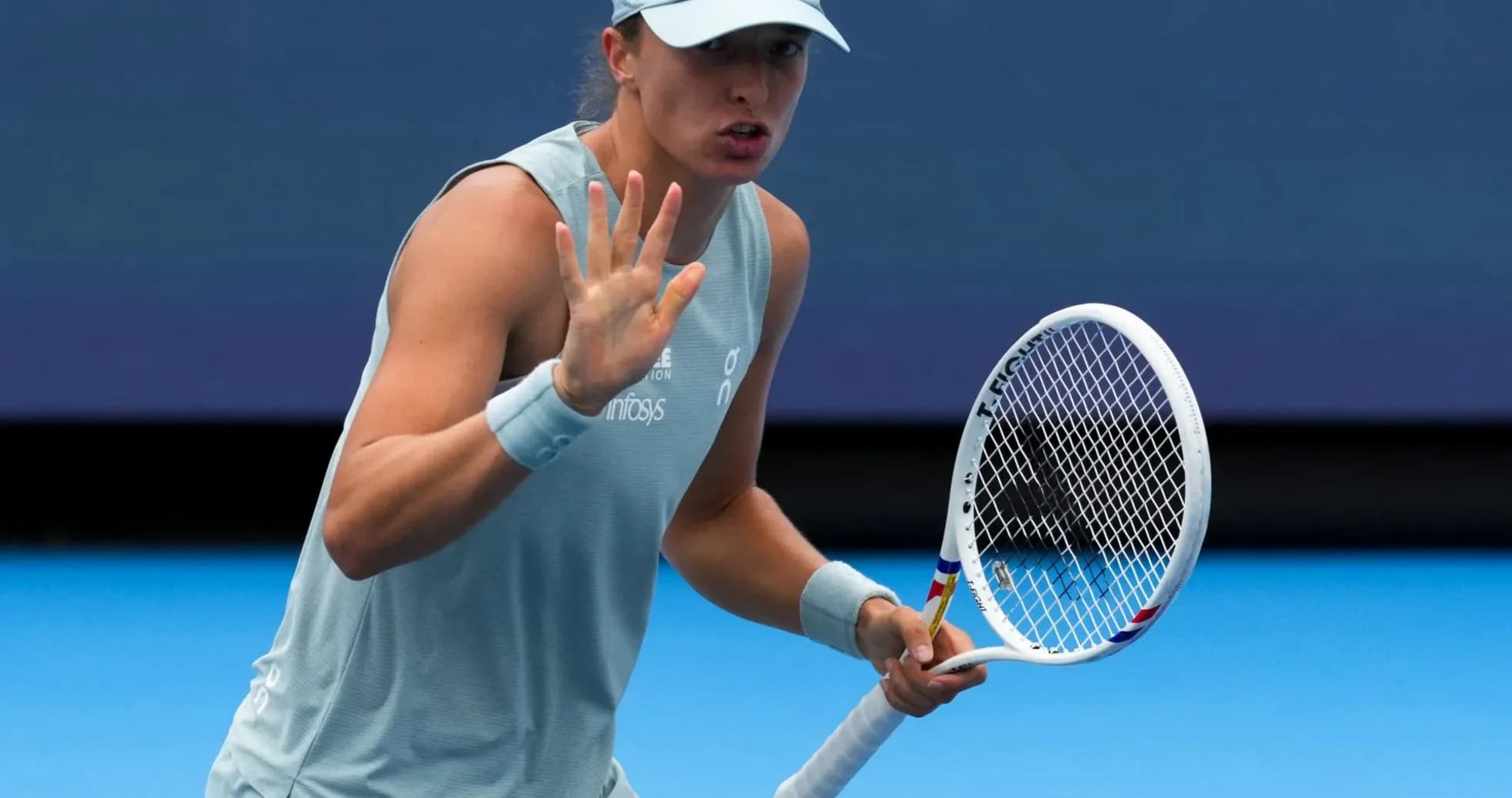 Tennis player gesturing during match on court