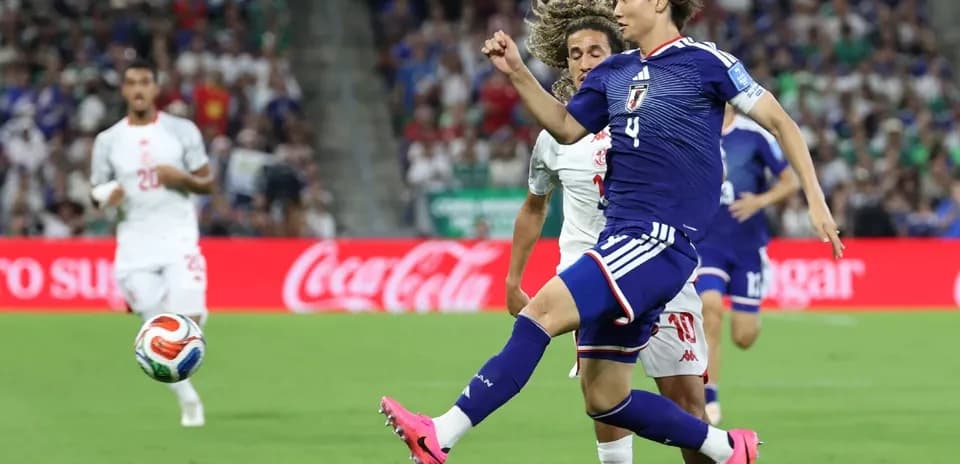 Japanese player kicking ball during match against opponent