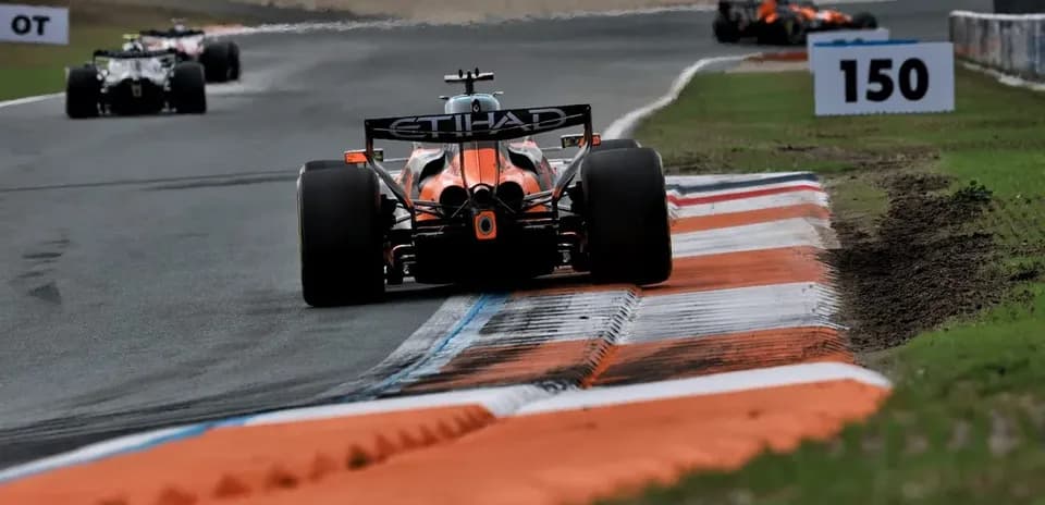 Formula 1 car navigating a racetrack corner