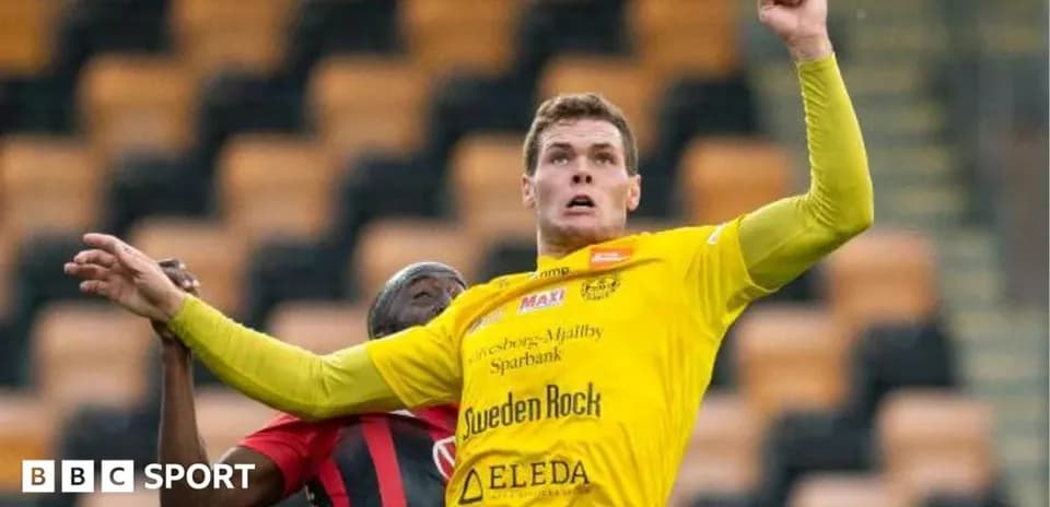 Player in yellow jersey jumping for a header