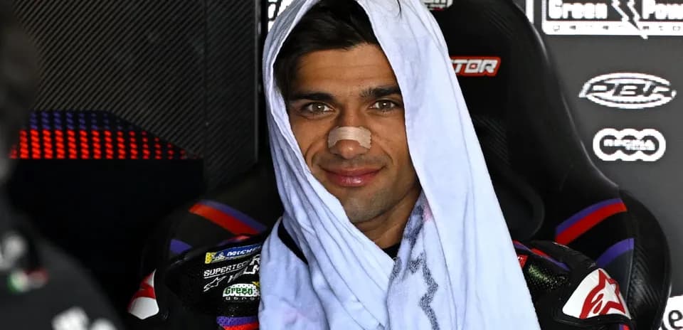 Motorsport athlete with towel and bandage on nose