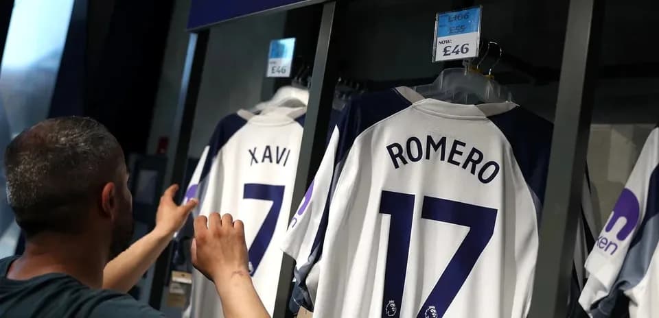 Customer examining football jerseys in store