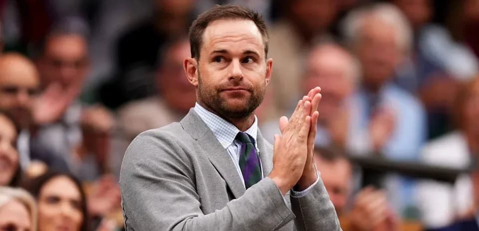 Man in a suit applauding at an event