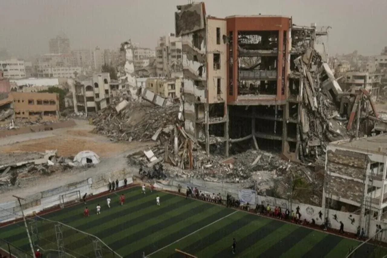 Football match occurring near destroyed buildings