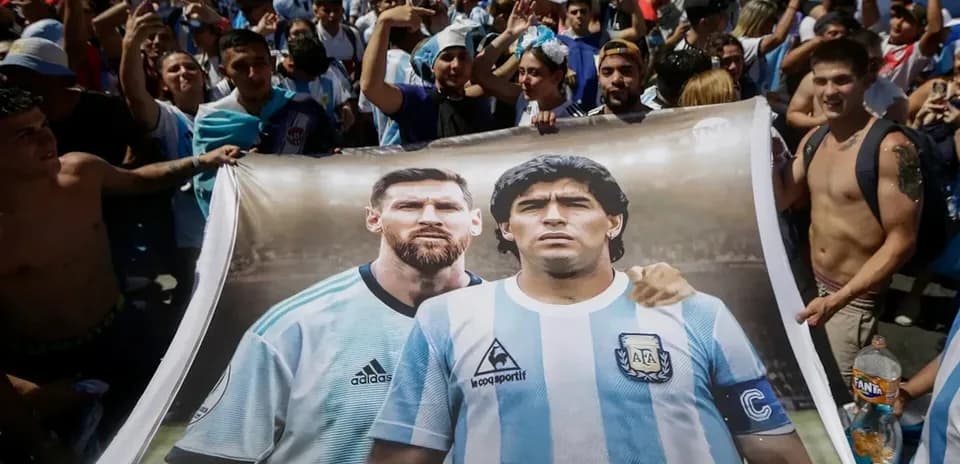 Fans holding a banner of Messi and Maradona