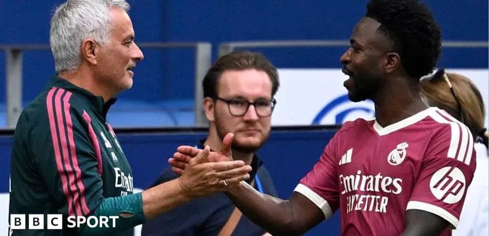 Two men shaking hands on football pitch