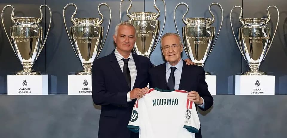 Mourinho and president holding jersey with trophies