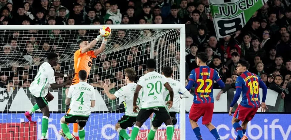 Goalkeeper catching ball during intense football match