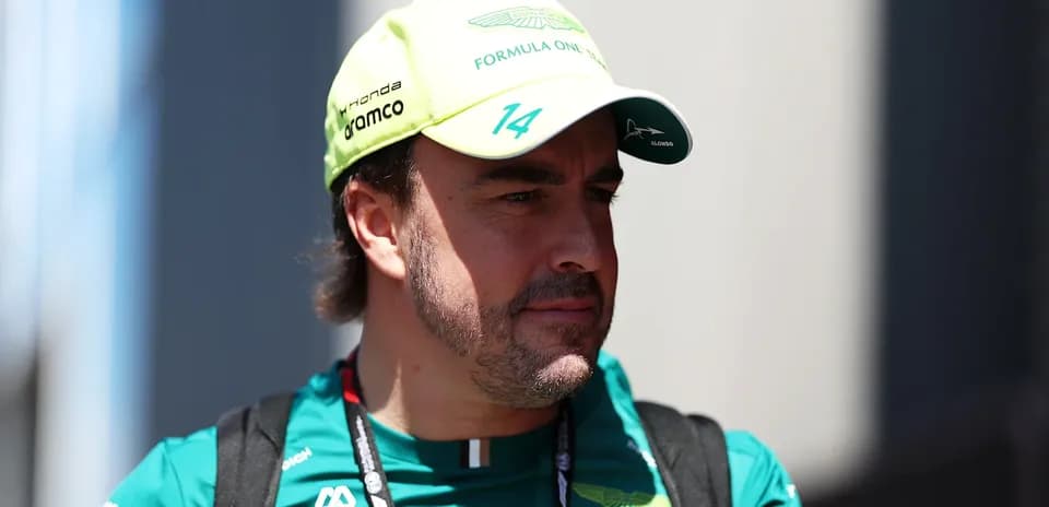 F1 driver wearing Aston Martin cap and team uniform