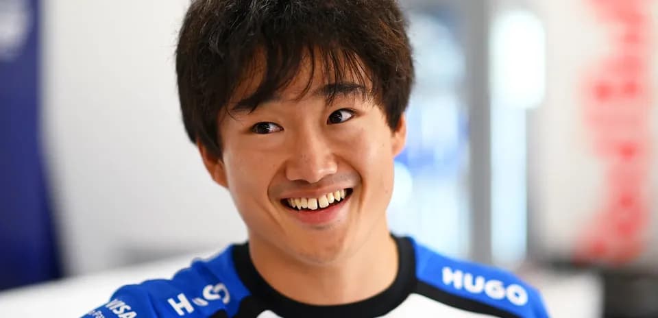 Driver smiling in team uniform during event