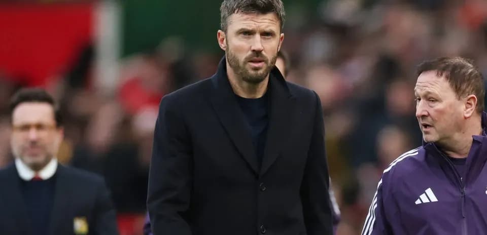 Coach walking on sideline with assistant during match