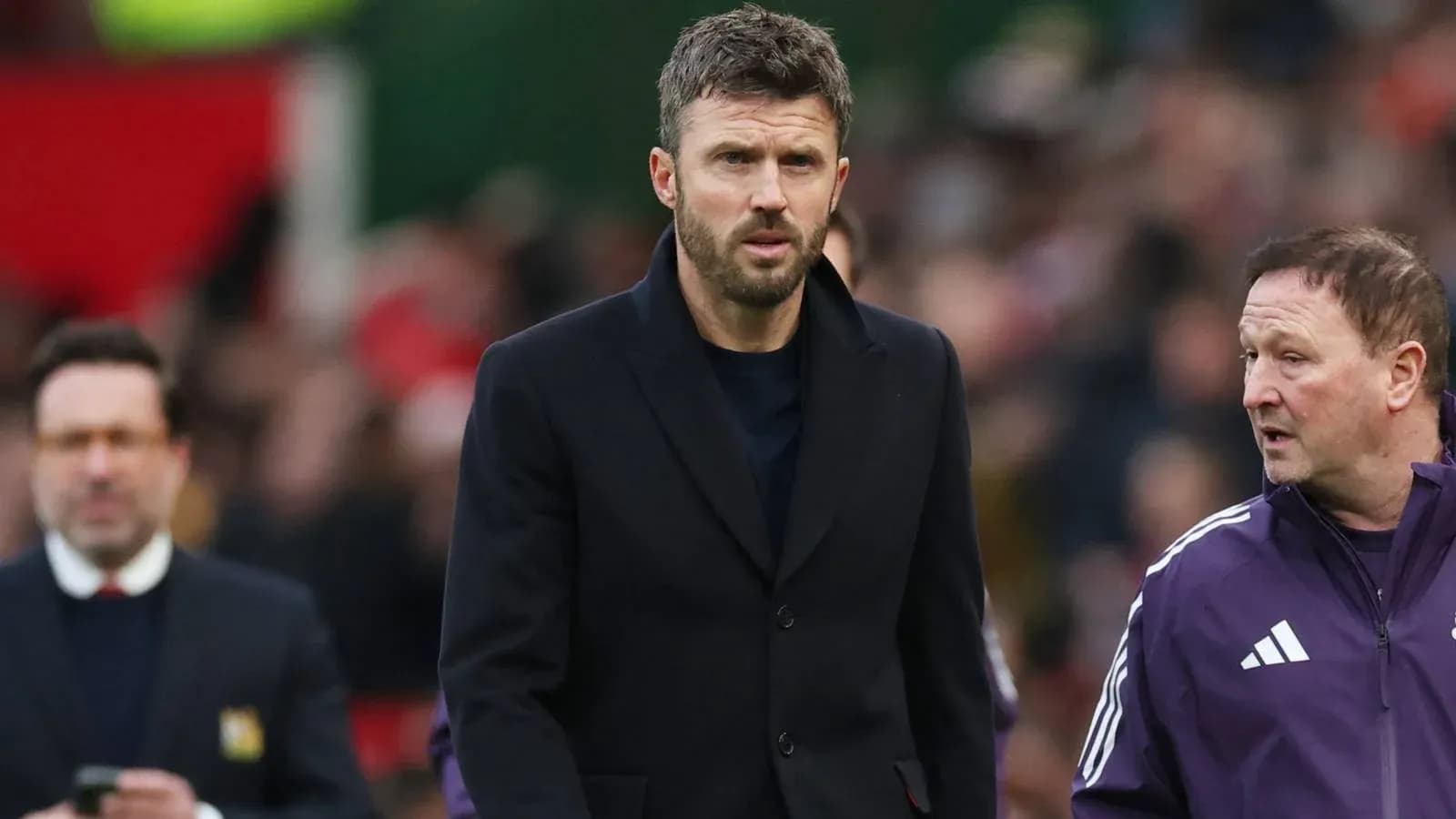 Coach walking on sideline with assistant during match