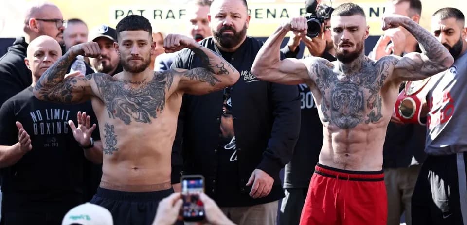 Two boxers flexing muscles at weigh-in event