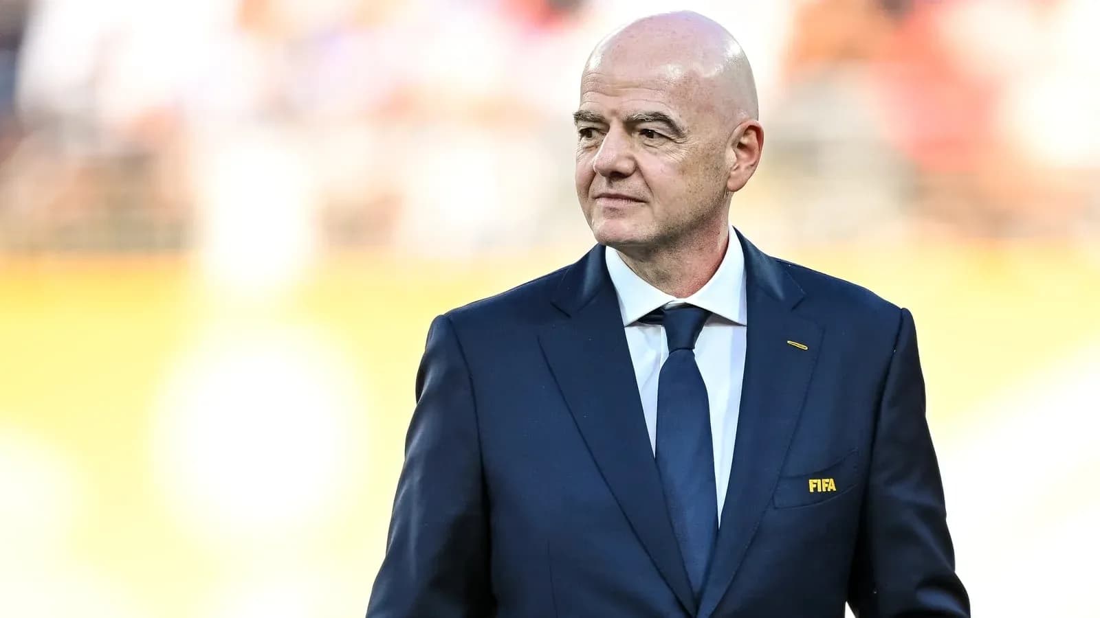 FIFA president walking on the pitch before match