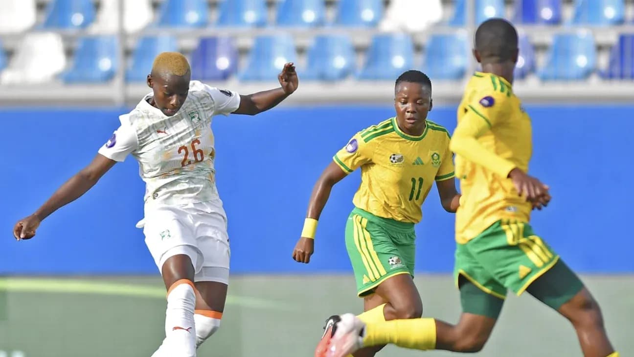 Ivorian player kicking ball against South African opponents Ivorian player kicking ball against South African opponents