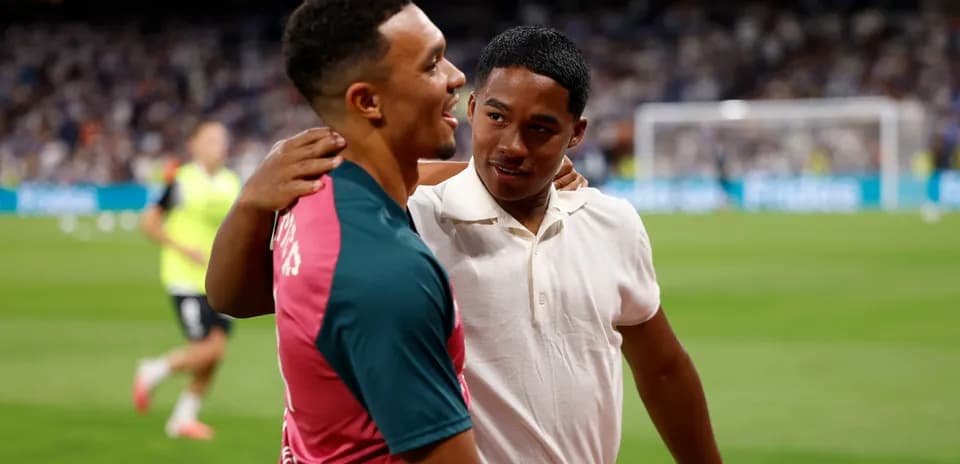 Two players interacting on the pitch before match