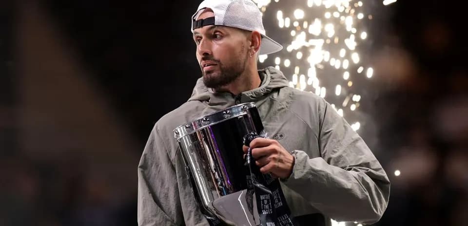 Athlete holding trophy with sparks in background