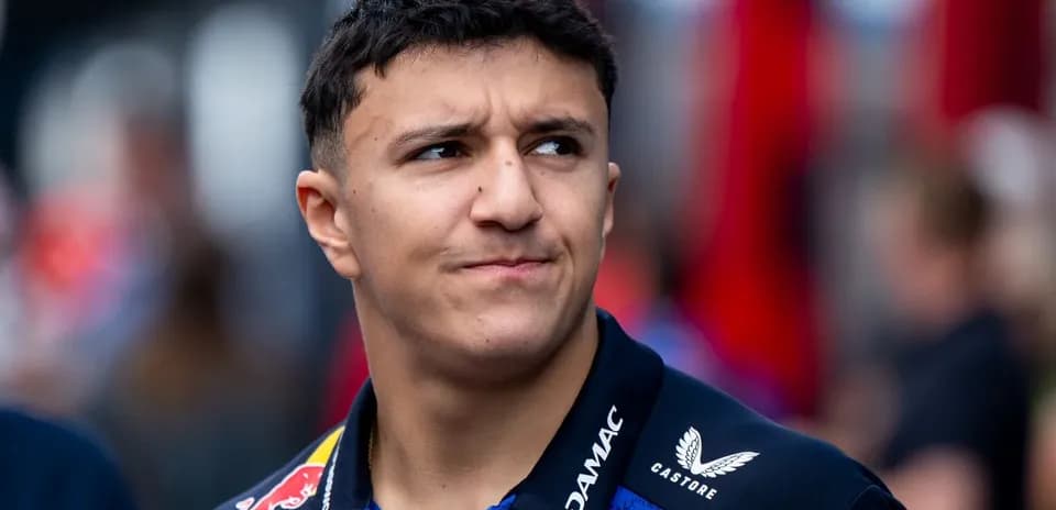 Young driver in team uniform at event