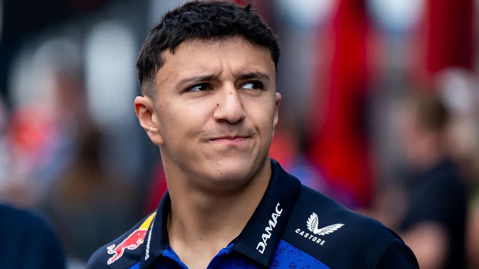 Young driver in team uniform at event