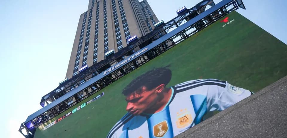 Building with large screen showing football match