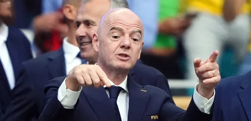 FIFA official speaking at event with audience behind