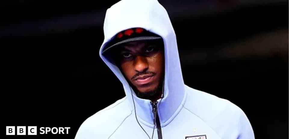 Sporting figure in hoodie preparing for event