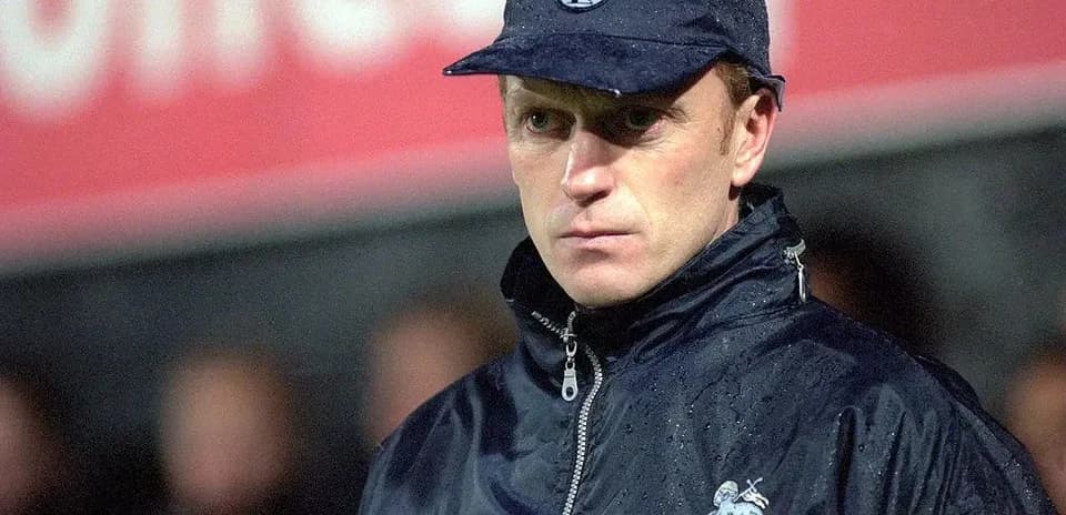 Preston North End manager during a rainy match