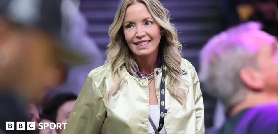 Woman in a gold jacket at a sports event
