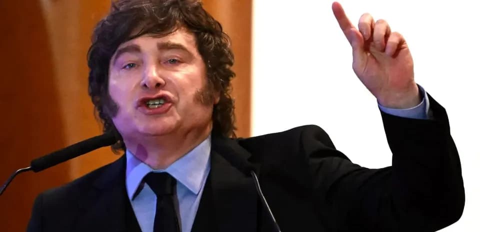 Speaker gesturing passionately at podium during event