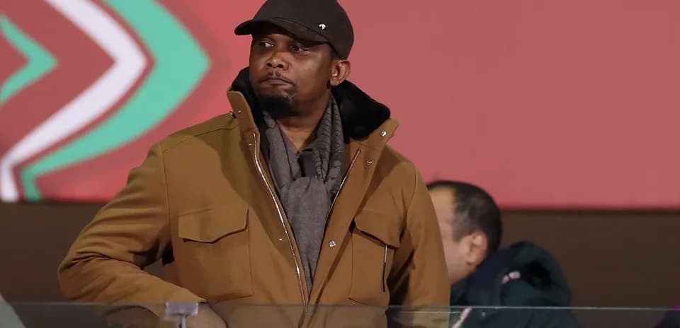 Man in brown coat at sporting event venue