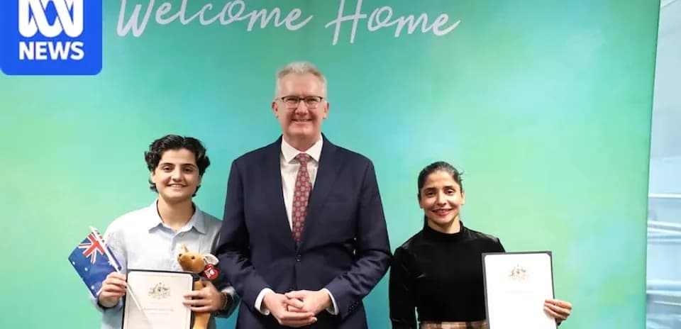 Three people celebrating citizenship ceremony with certificates