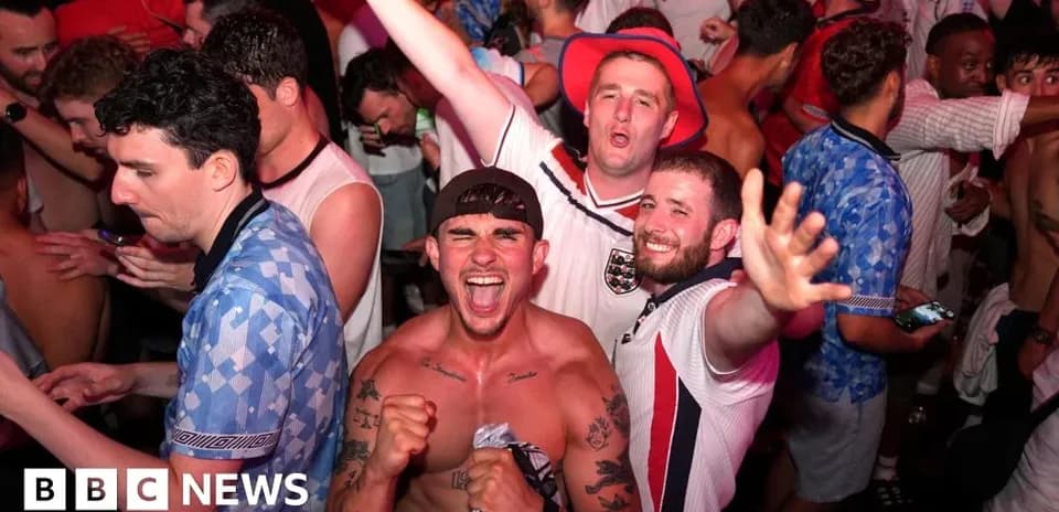 Football fans celebrating in a crowded venue