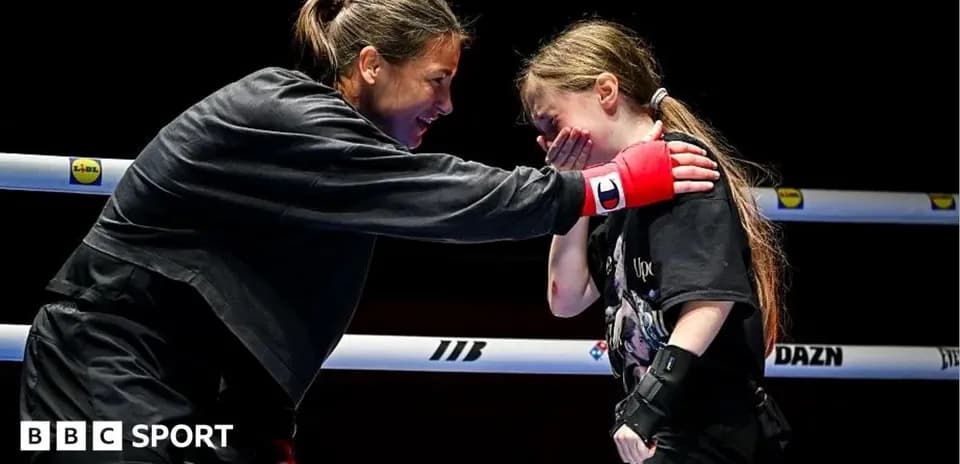 Boxer comforting young girl in the ring