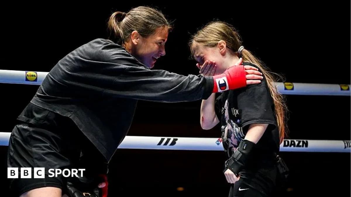 Boxer comforting young girl in the ring