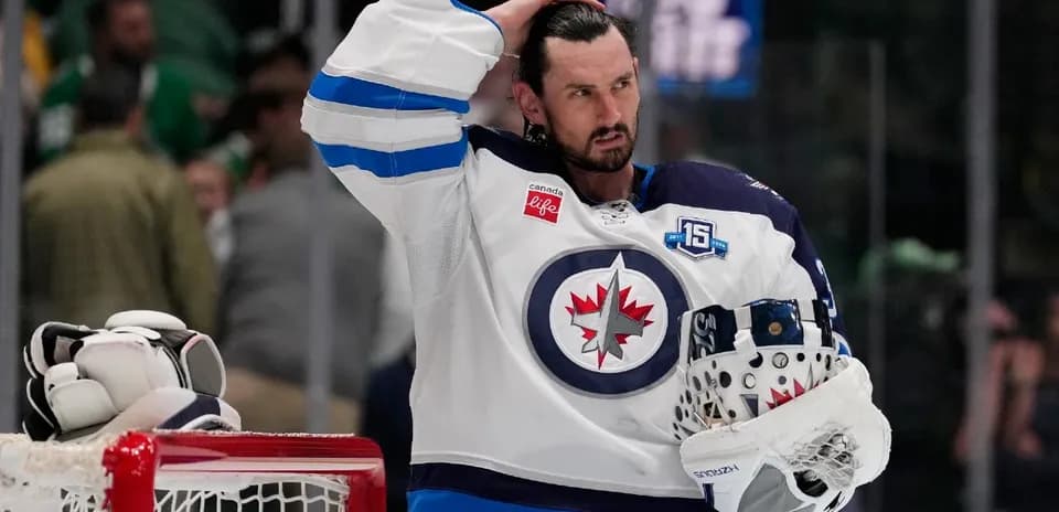 Hockey player in Winnipeg Jets jersey with helmet
