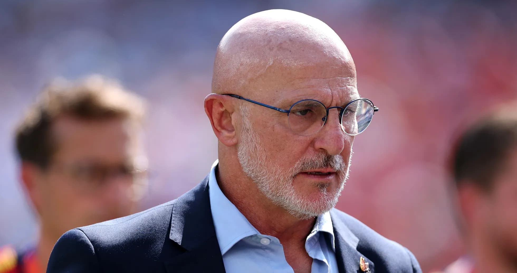 Bald man in glasses during match day