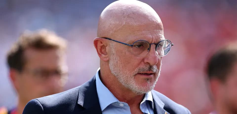 Bald man in glasses during match day