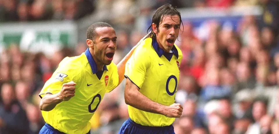 Arsenal players celebrating a goal on the field