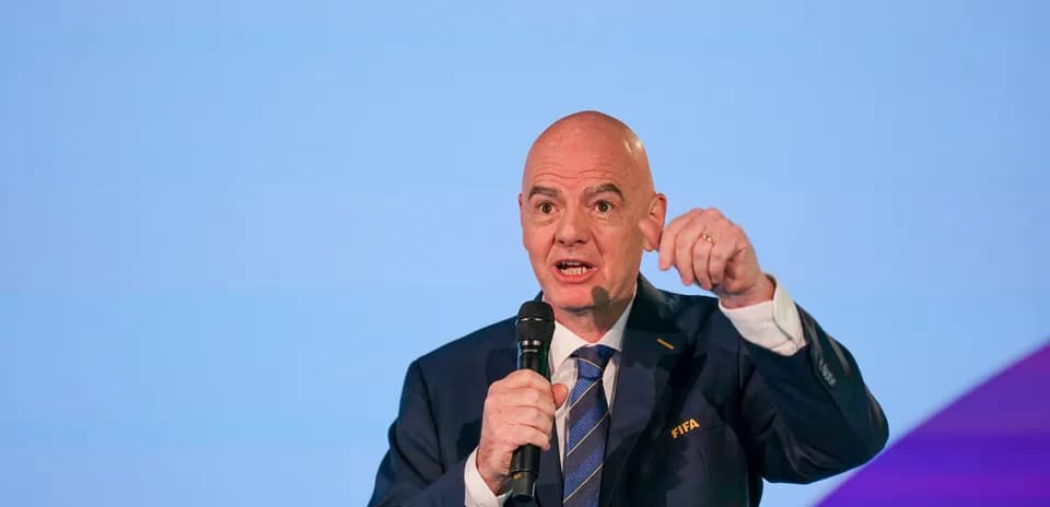 FIFA official speaking at event with microphone