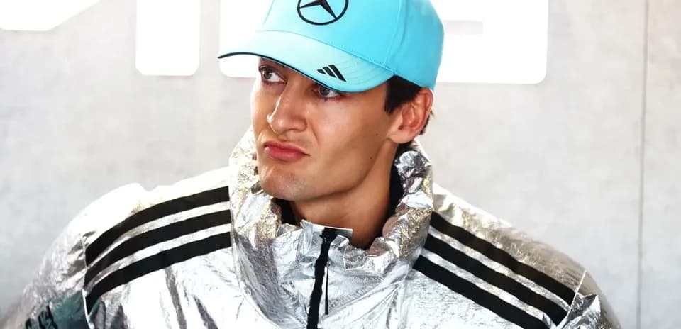 Yoshimura team member wearing silver jacket and cap