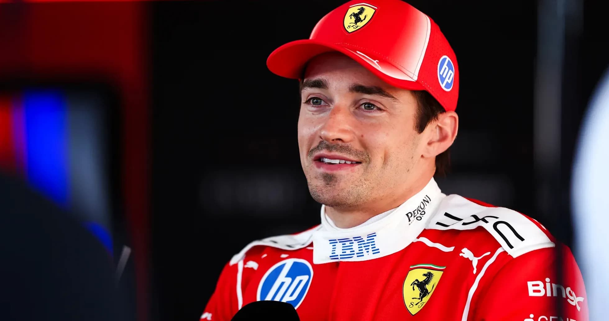 Formula 1 driver speaking in Ferrari team attire