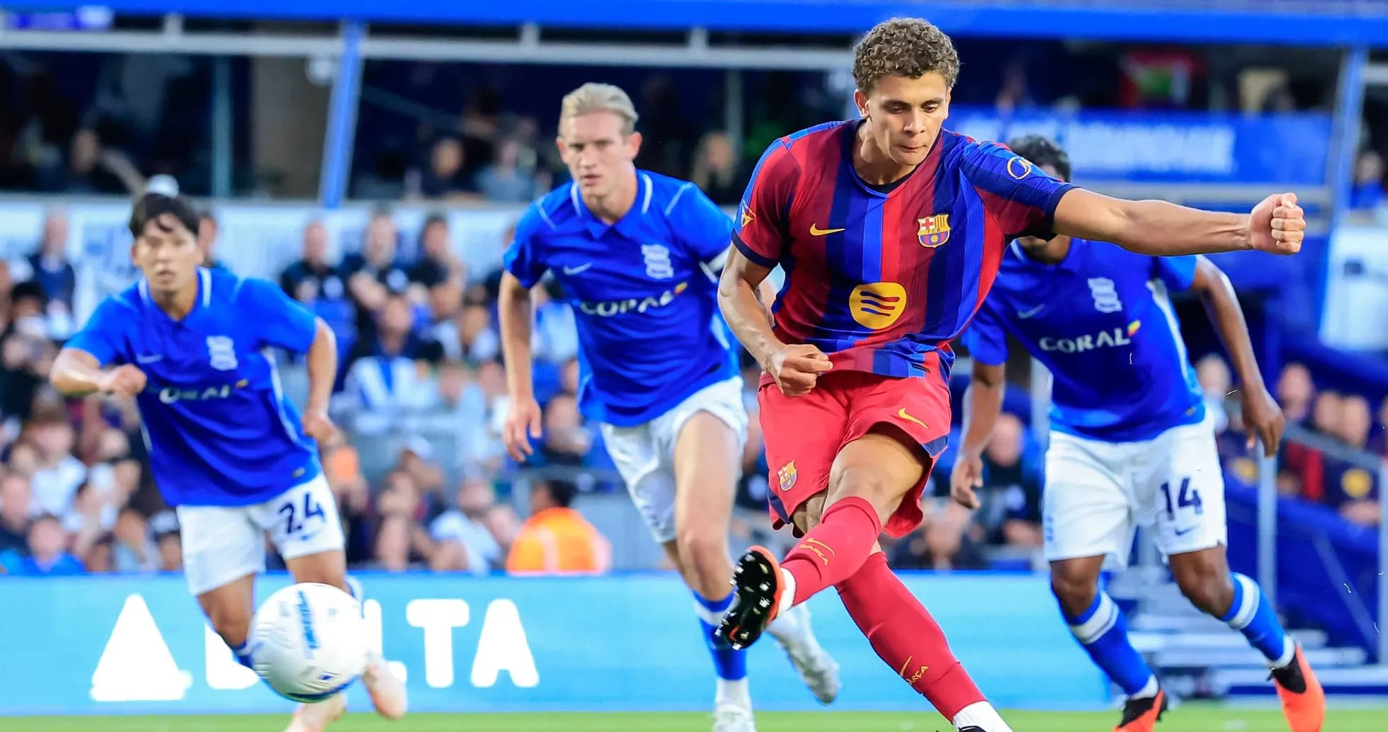 Barcelona player taking a penalty kick during match