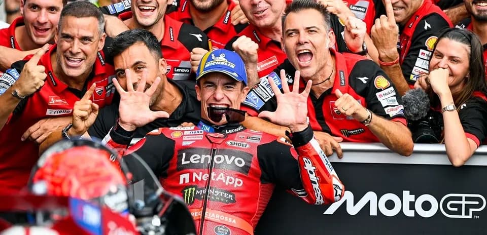 Ducati team celebrating victory with rider in pit