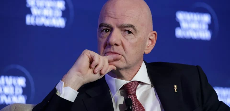 Man speaking at a conference with a microphone