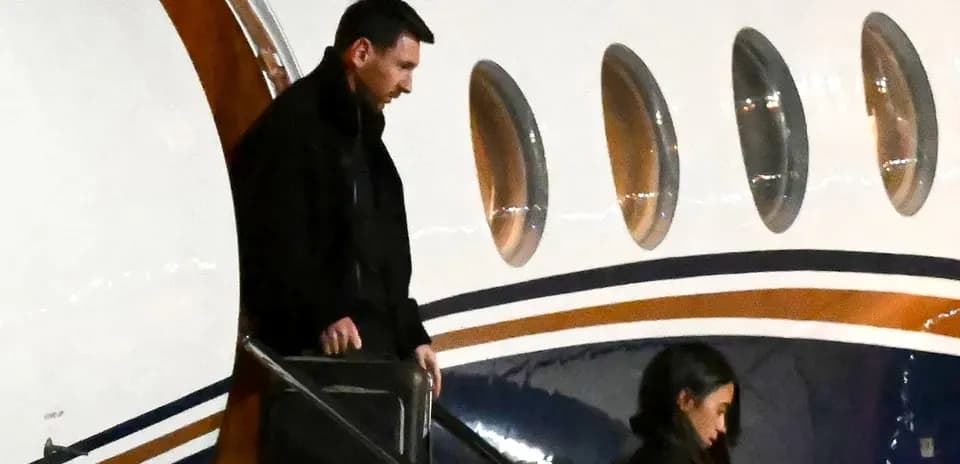 Lionel Messi exiting private jet with companion